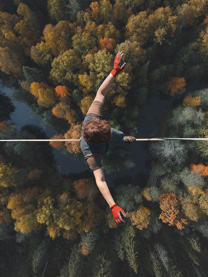 Highline over the forest. Rope walker walks on a rope at high al